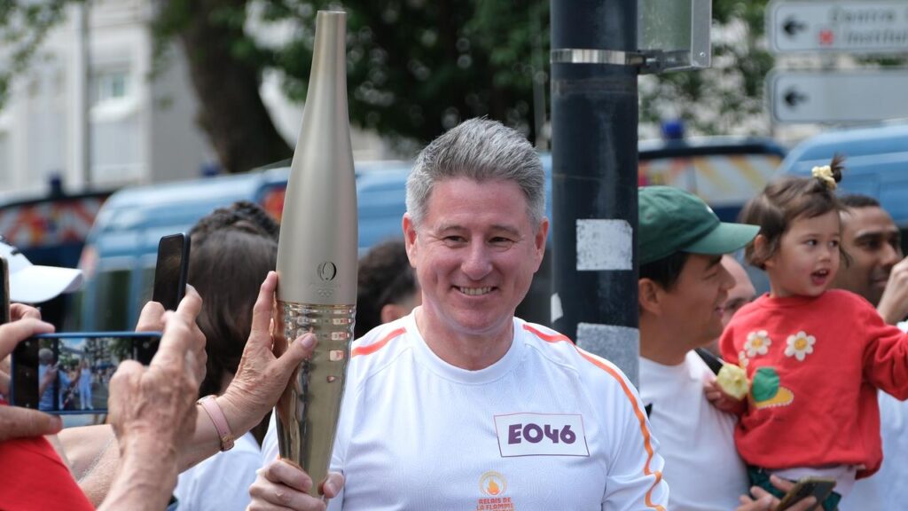 nine-boss-mike-sneesby-carries-olympic-flame-in-paris-as-company-goes-on-strike